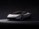 Nouveau Tesla Roadster gris vu de trois quarts avant, sur fond noir